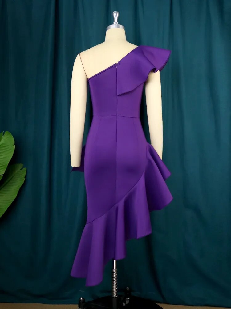 Back view of a purple one-shoulder dress with ruffles and asymmetrical hem on a mannequin