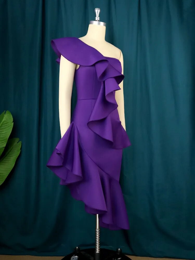 Close-up of a purple one-shoulder dress with cascading ruffles on a mannequin