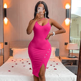 Woman in a pink bodycon dress with an asymmetrical neckline and a high slit, taking a mirror selfie.