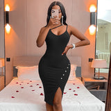Woman in a black bodycon dress with an asymmetrical neckline and a high slit, taking a mirror selfie.
