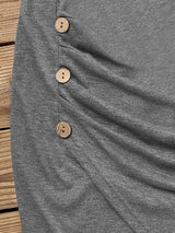close-up of wooden buttons on a gray ruched dress