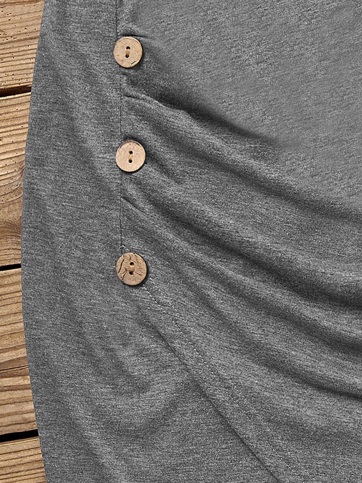close-up of wooden buttons on a gray ruched dress