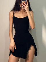 woman taking selfie in black cocktail dress