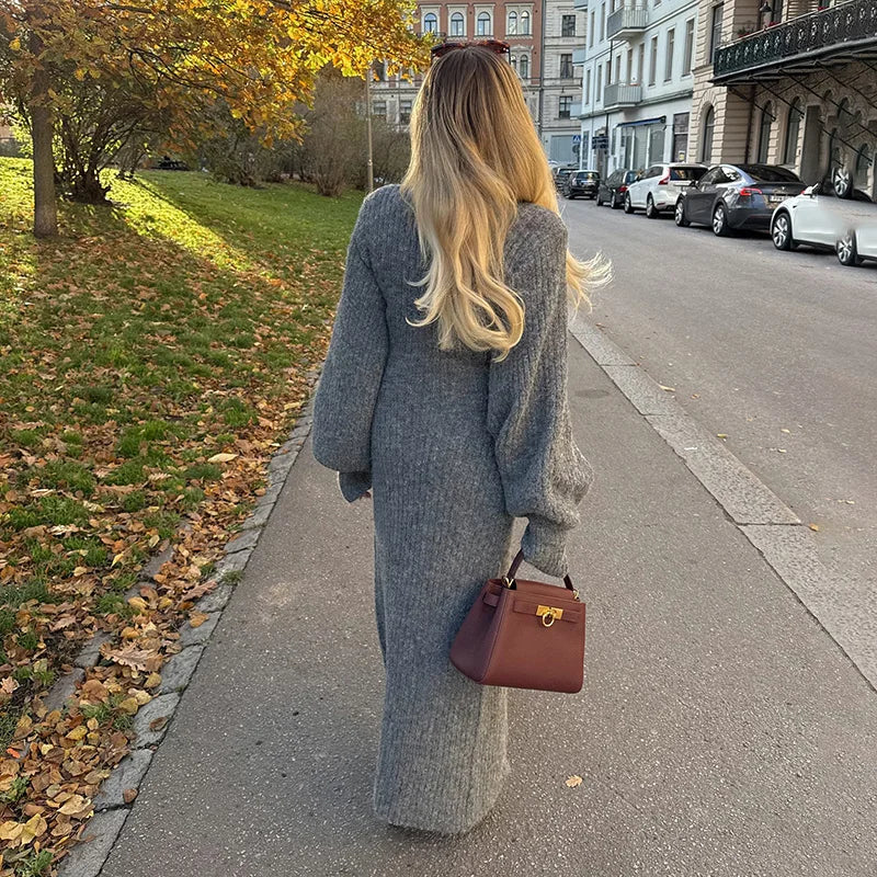 woman from behind wearing a long gray cardigan dress