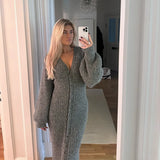 woman taking a mirror selfie wearing a gray ribbed knit maxi dress