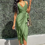 woman wearing a green satin wrap dress with a tie waist