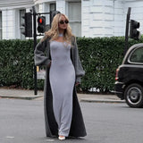 woman wearing a long gray cardigan over a gray maxi dress