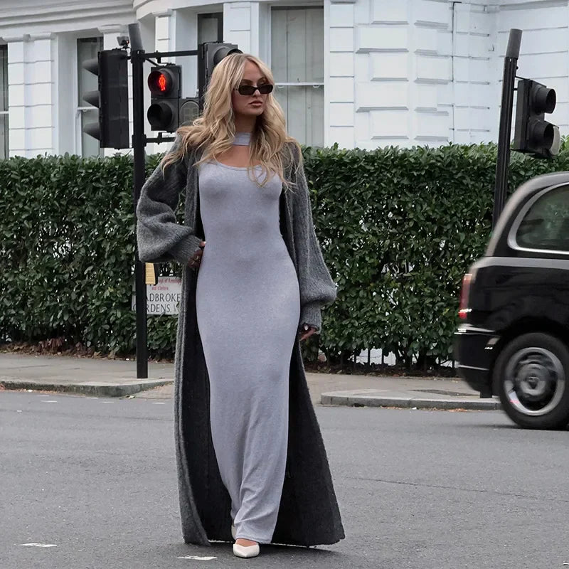 woman wearing a long gray cardigan over a gray maxi dress