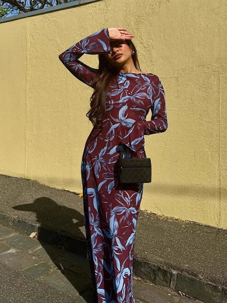 Woman in a floral print maxi dress, shielding her eyes from the sun.