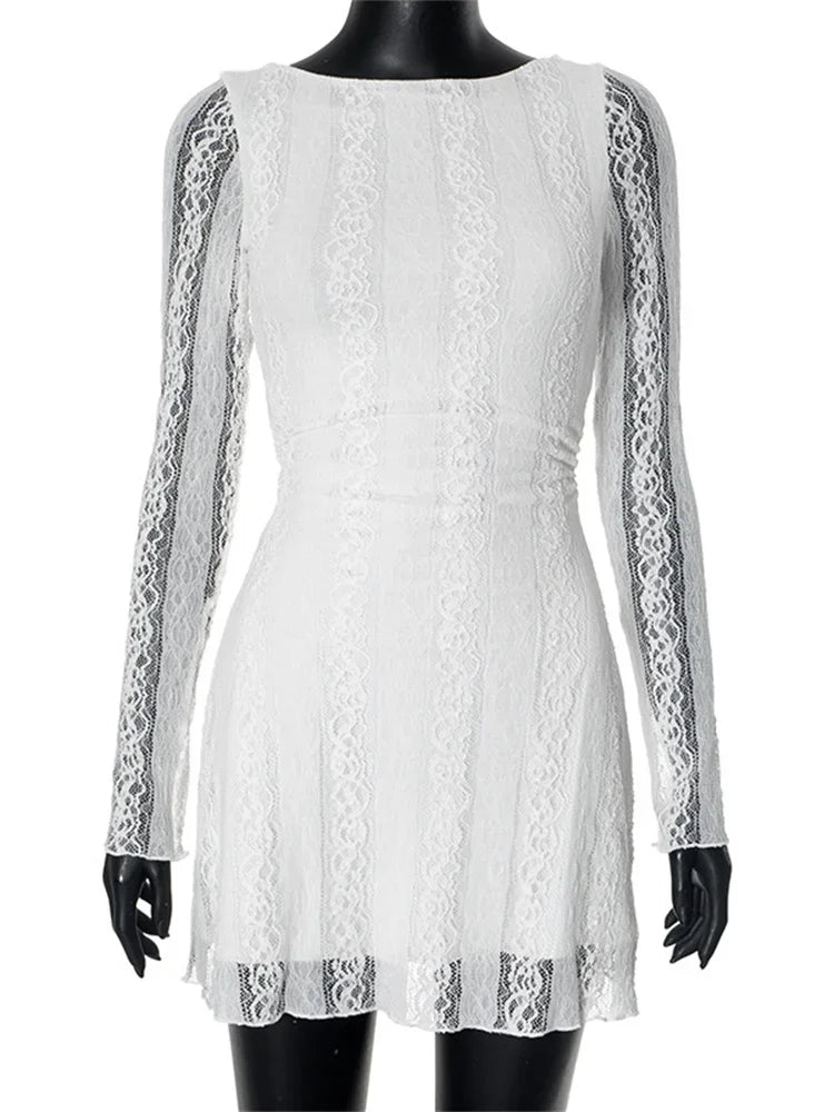 White lace dress displayed on a mannequin with black gloves.