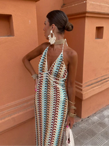 Close-up of the woman's upper body, showing the details of the dress neckline and jewelry.