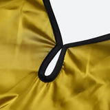 A close-up view of the neckline of a long, yellow dress with a black trim. The neckline has a cutout detail and a loop.