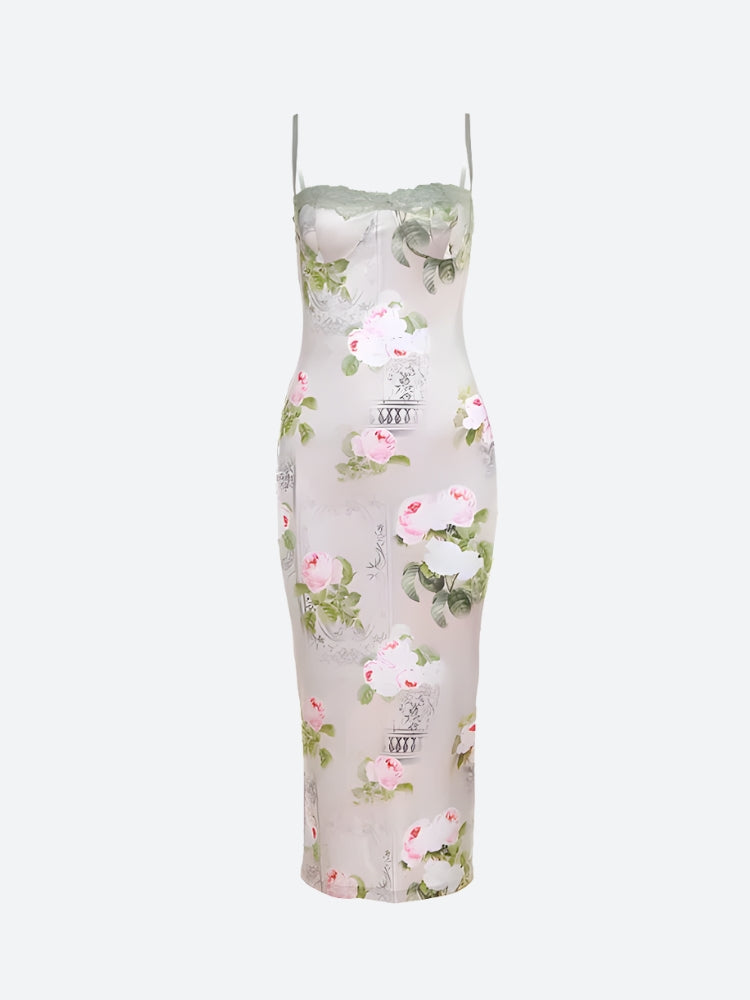 A floral print satin slip dress with green lace trim, laid flat against a white background.