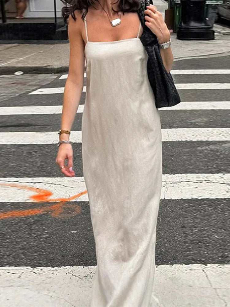 close up of woman in beige slip dress on a crosswalk