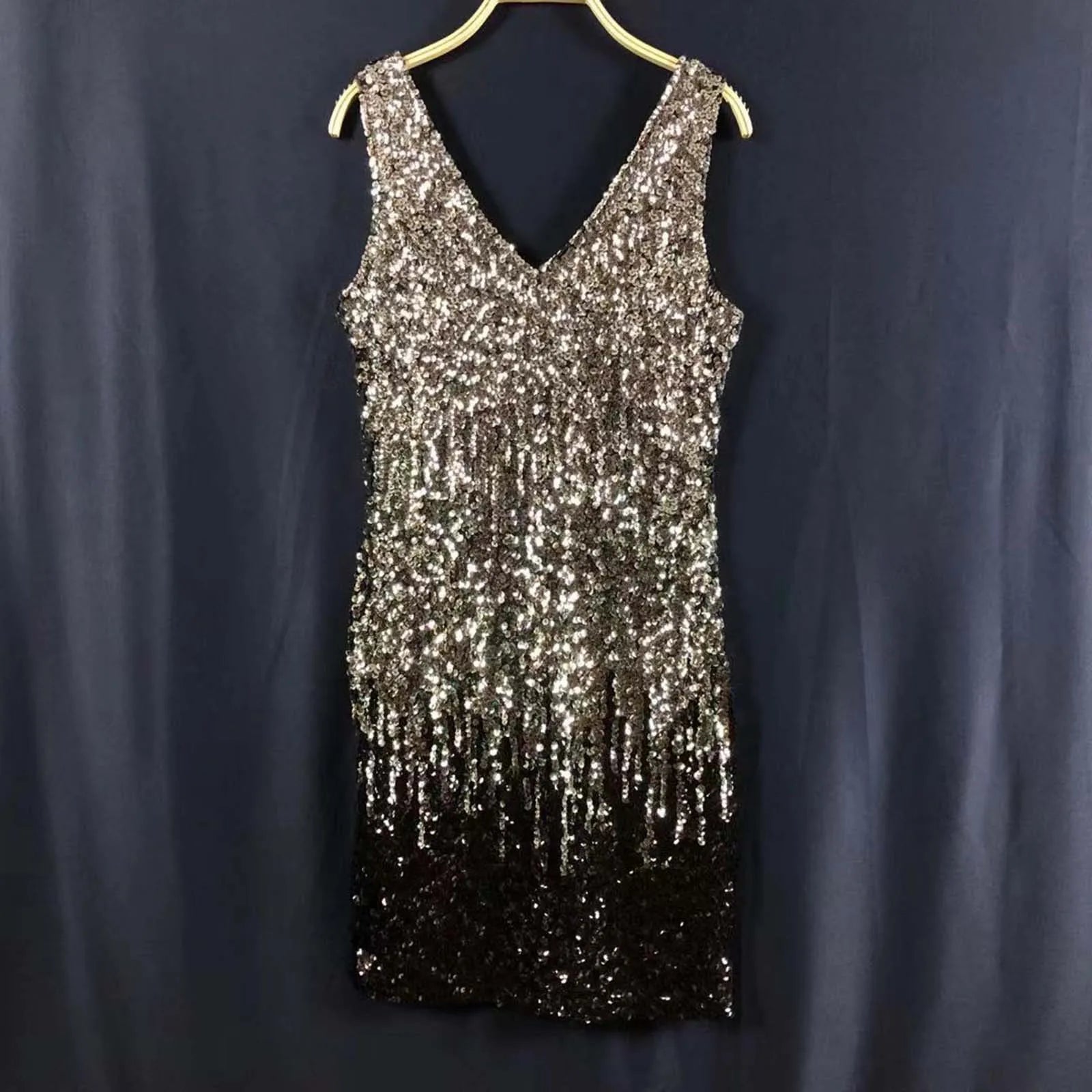 A sleeveless V-neck sequined dress with a silver to black ombre effect.