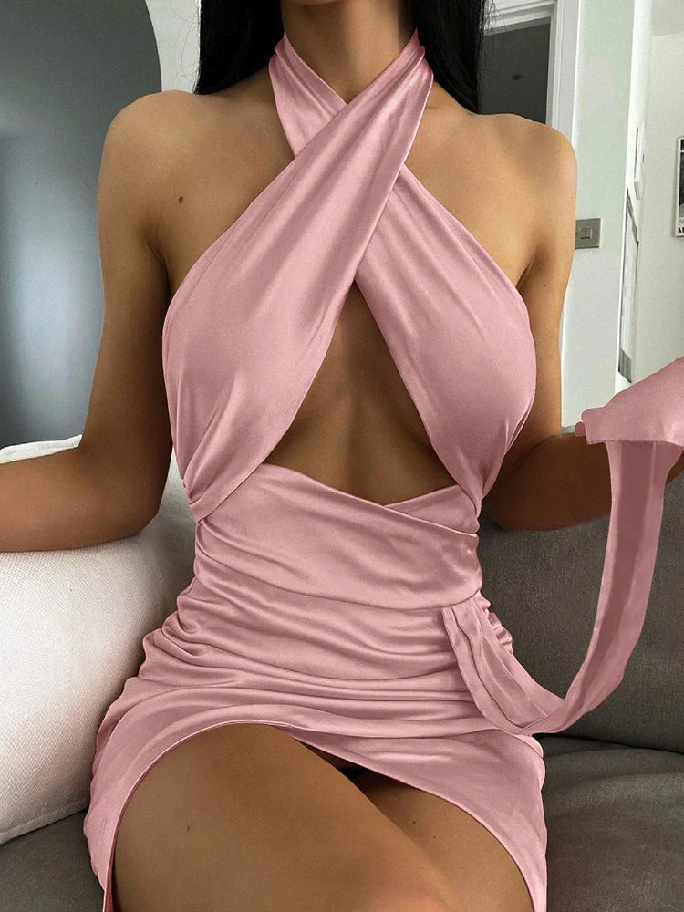 woman wearing a pink halter neck ruched mini dress