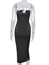 Back view of a black strapless bodycon maxi dress with sheer side panels.