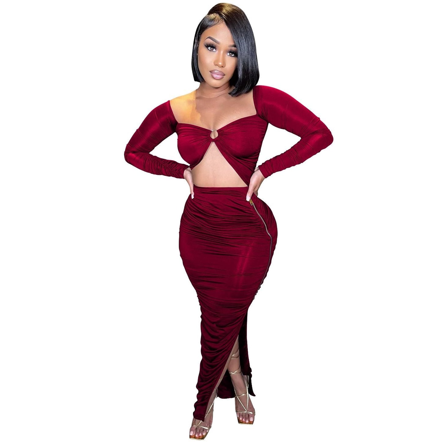 woman wearing a burgundy ruched two-piece set with a cutout top and high slit skirt