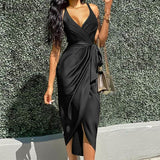 woman wearing a black satin wrap dress with a tie waist