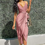 woman wearing a pink satin wrap dress with a tie waist