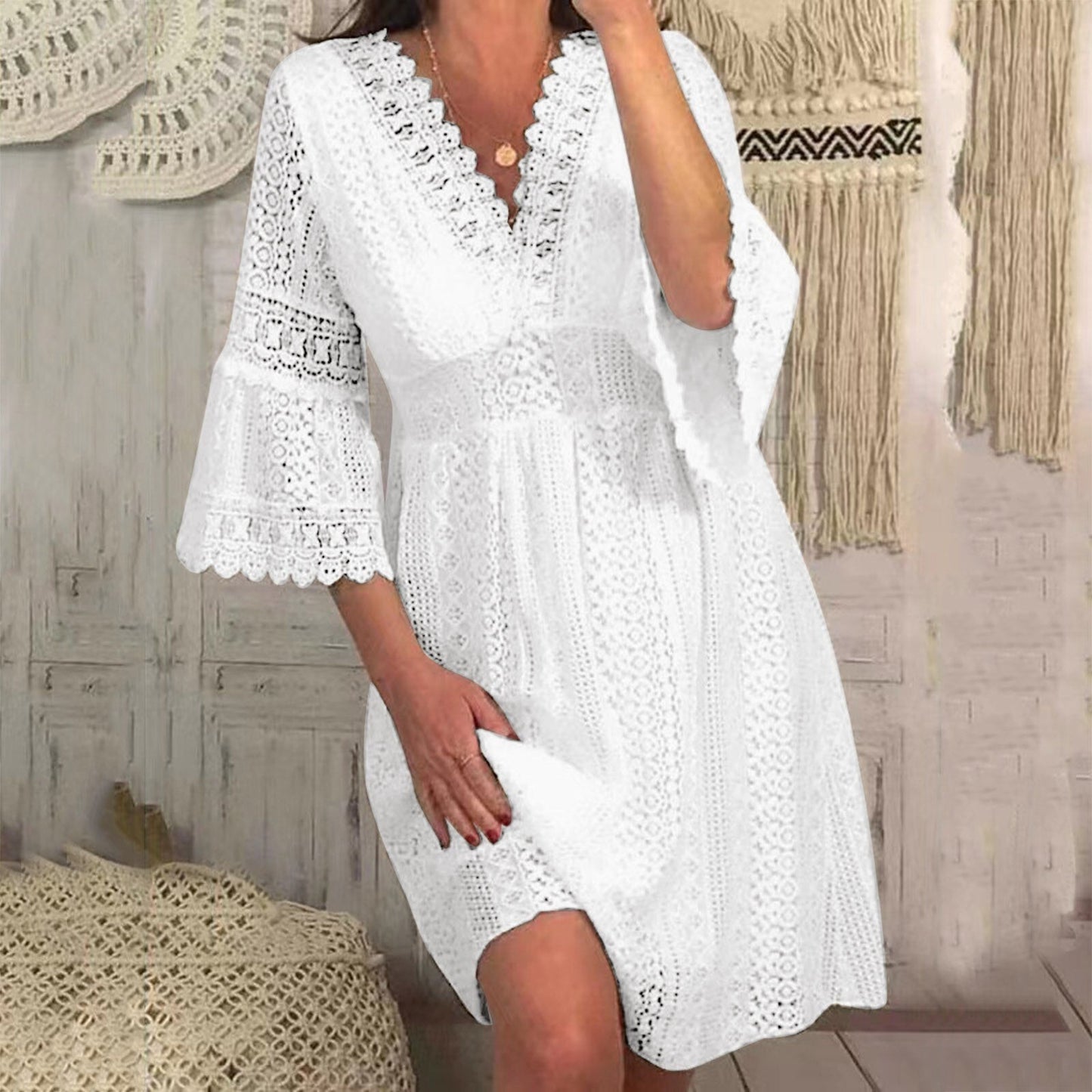 Woman posing in a white lace dress