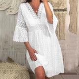 Woman posing in a white lace dress
