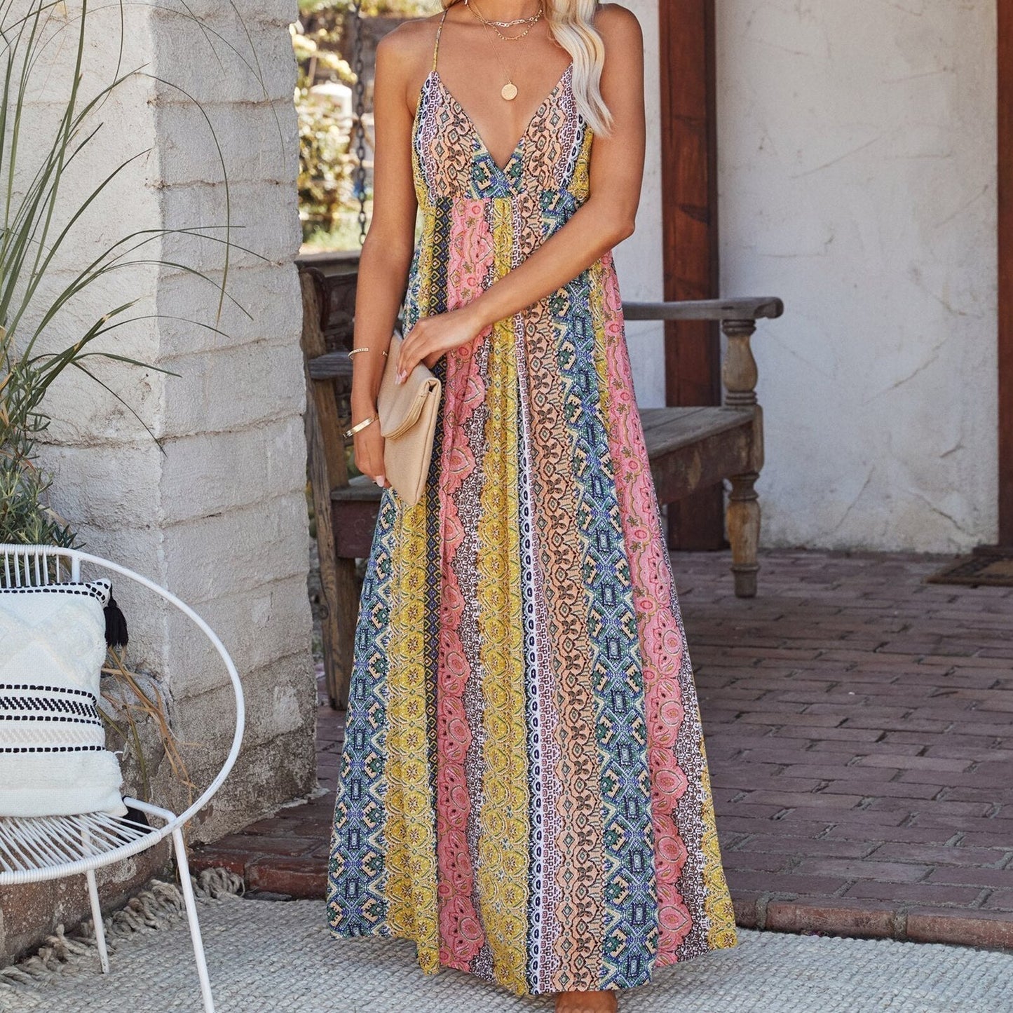 Woman in a vibrant, patterned maxi dress with a v-neck.