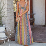 Woman in a vibrant, patterned maxi dress with a v-neck.