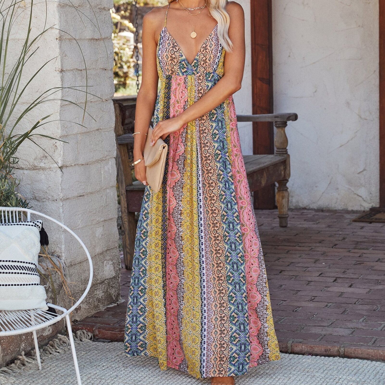 Woman in a vibrant, patterned maxi dress with a v-neck.