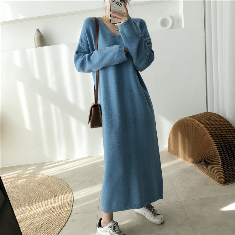 Woman wearing a long blue knit dress and white sneakers