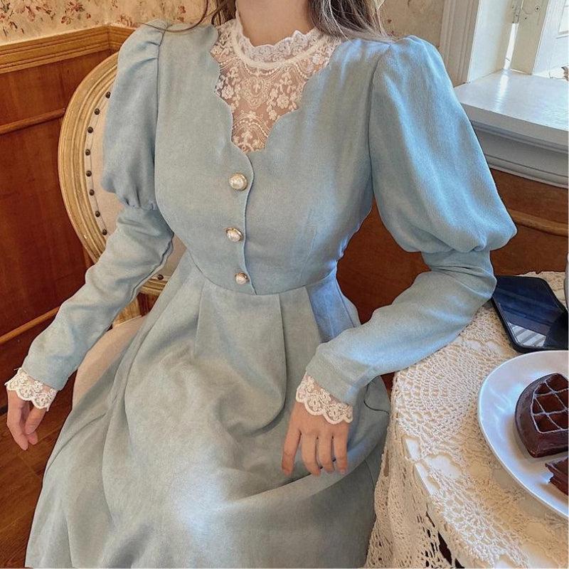 detailed view of the lace neckline and sleeves of a light blue dress