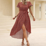 woman in red floral print wrap dress walking