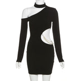 A black mini dress with an asymmetrical neckline, long sleeves, and a cut-out with pearl embellishment displayed on a mannequin.