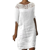 A white dress with a lace neckline and three-quarter sleeves.