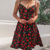 woman wearing a black and red floral print mini dress with a tie-front neckline and cut-out detail