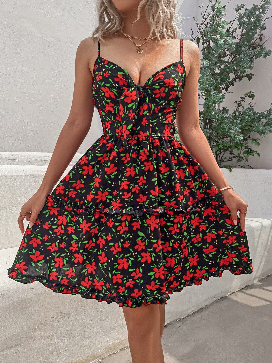 woman wearing a black floral print mini dress with a tie-front neckline and cut-out detail