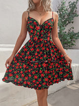woman wearing a black floral print mini dress with a tie-front neckline and cut-out detail
