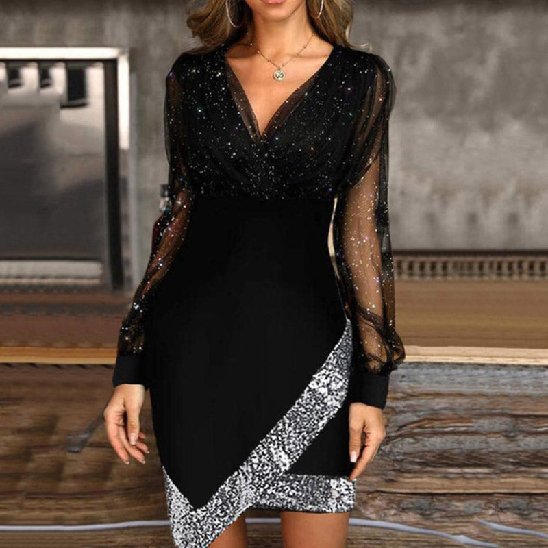 woman wearing a black sparkly long-sleeved dress with an asymmetrical sequined hem