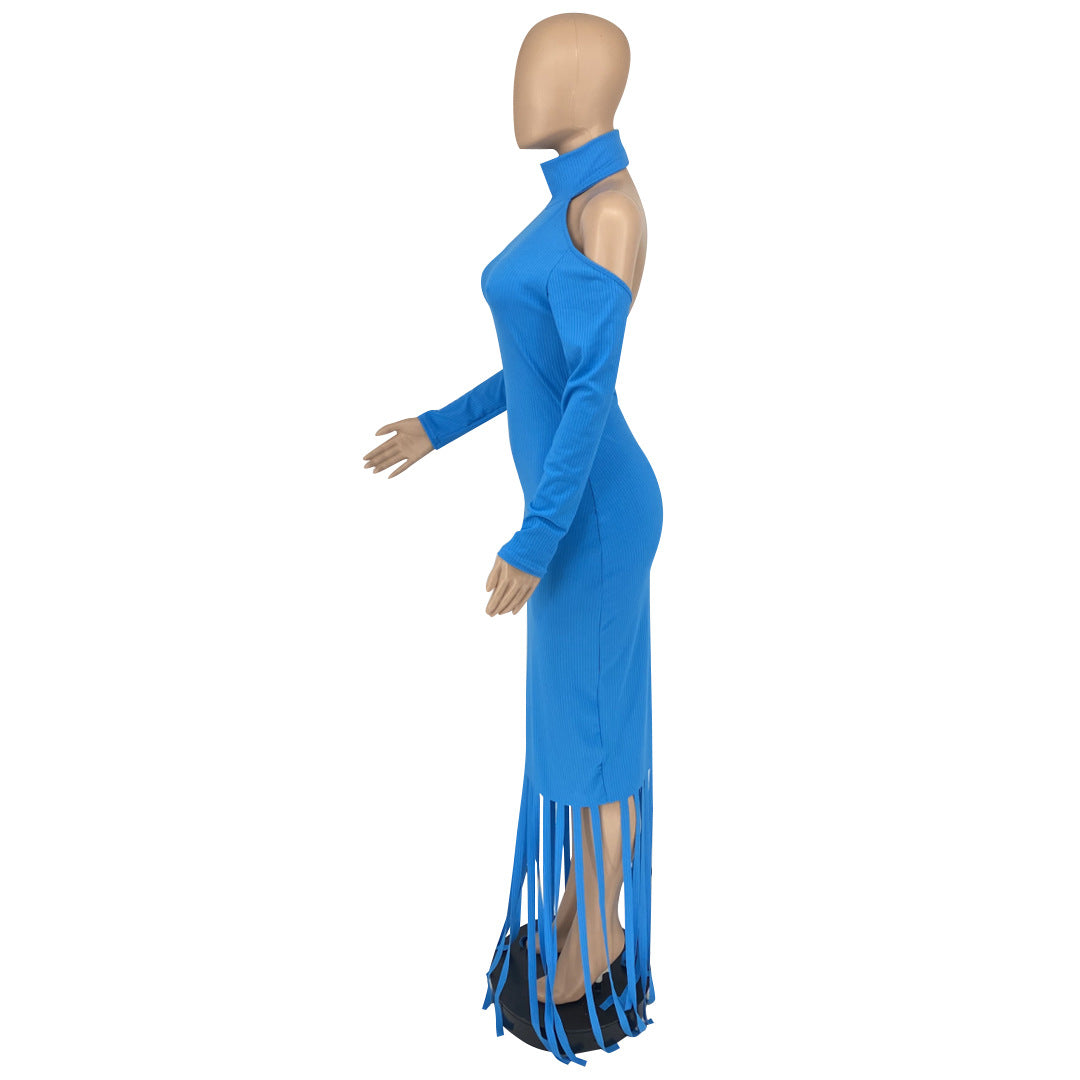 Mannequin wearing a blue long-sleeved dress with cut-out shoulders and fringe hem, side view.