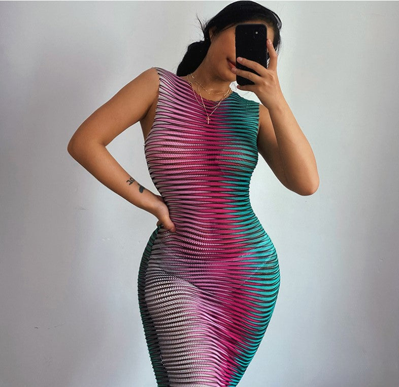 Woman taking a selfie in a pink and teal striped sleeveless bodycon dress