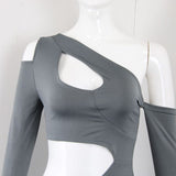 Close-up of the neckline and cut-out detail of the gray dress on a mannequin