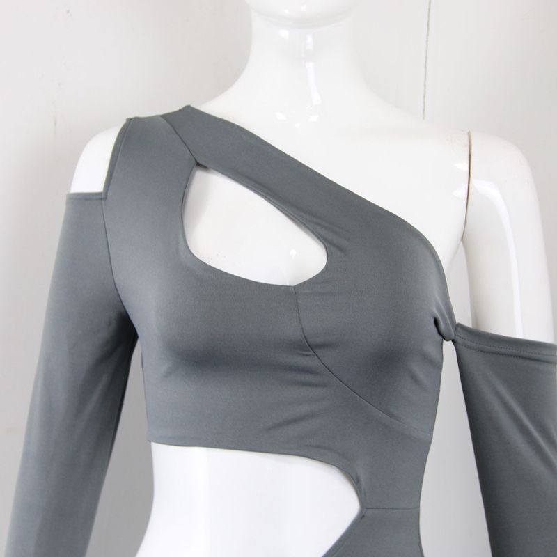 Close-up of the neckline and cut-out detail of the gray dress on a mannequin