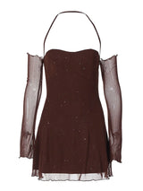 A brown, sparkly mini dress with sheer, off-the-shoulder sleeves and a halter neckline is displayed against a white background.