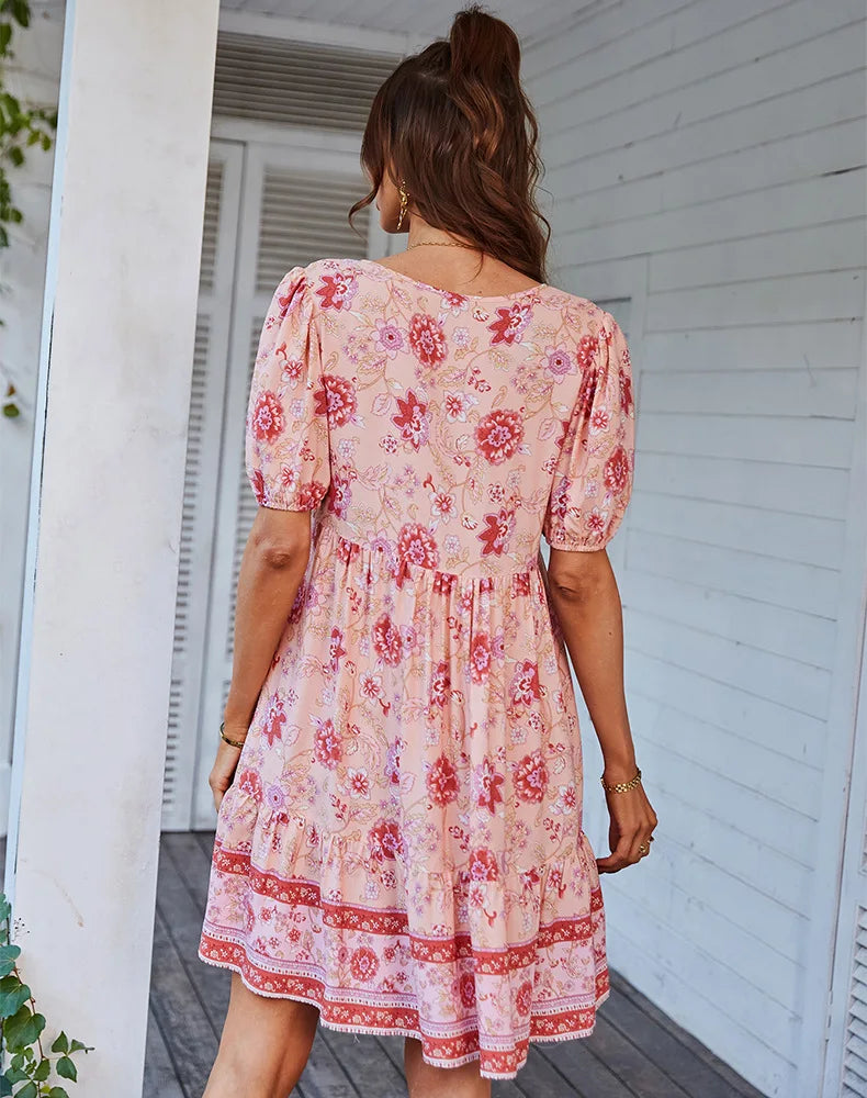 Back view of a woman wearing a pink floral print mini dress