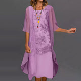 A woman wearing a purple floral lace dress with a sheer overlay.