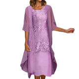 A woman wearing a lavender floral lace dress with a sheer overlay.