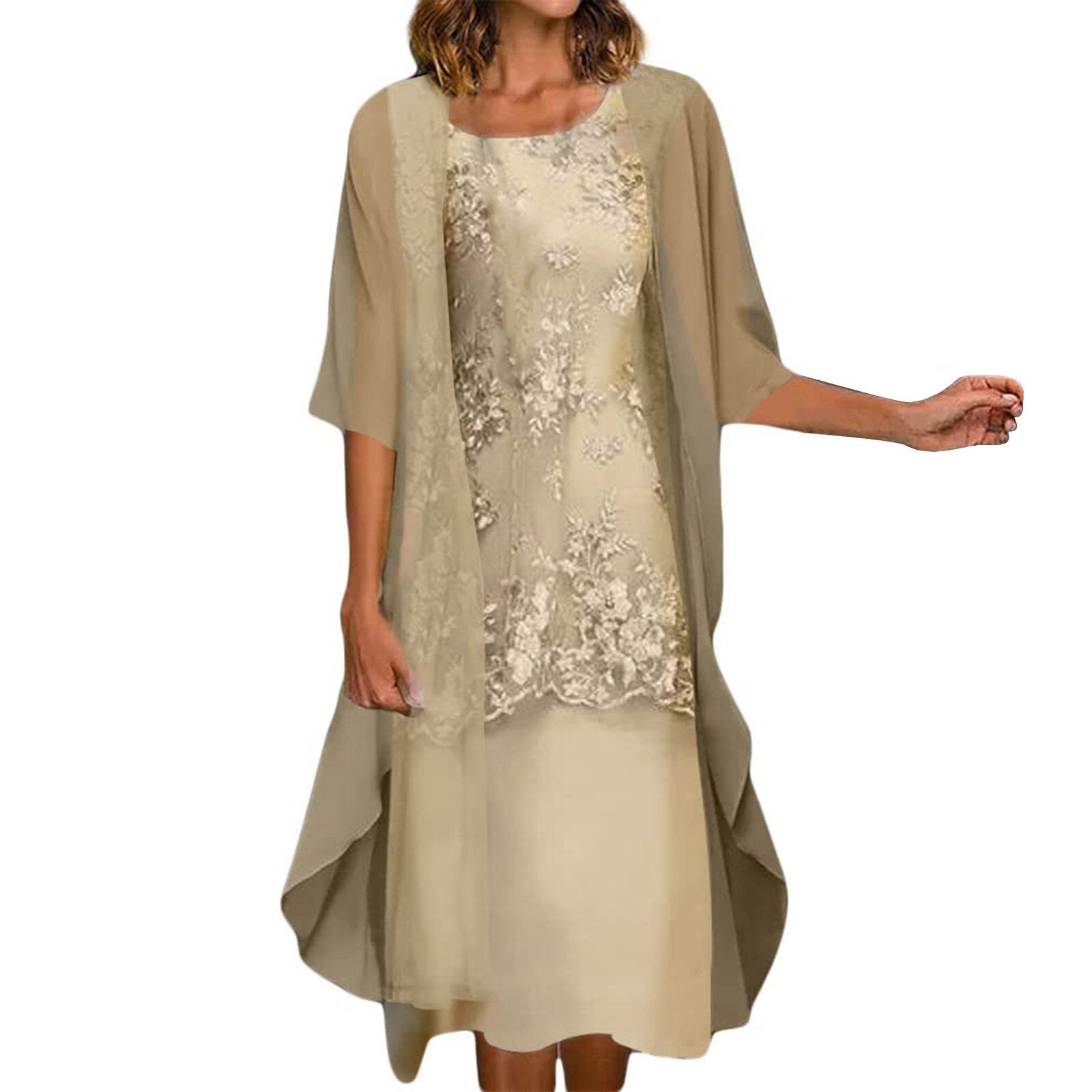 A woman wearing a beige floral lace dress with a sheer overlay.
