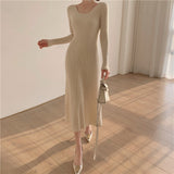 A woman wearing a beige ribbed knit midi dress with long sleeves and a square neckline, paired with white heels and a white handbag.