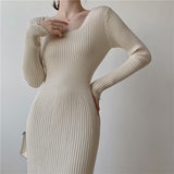 Close-up of a woman wearing a beige ribbed knit midi dress, showing the texture and square neckline.