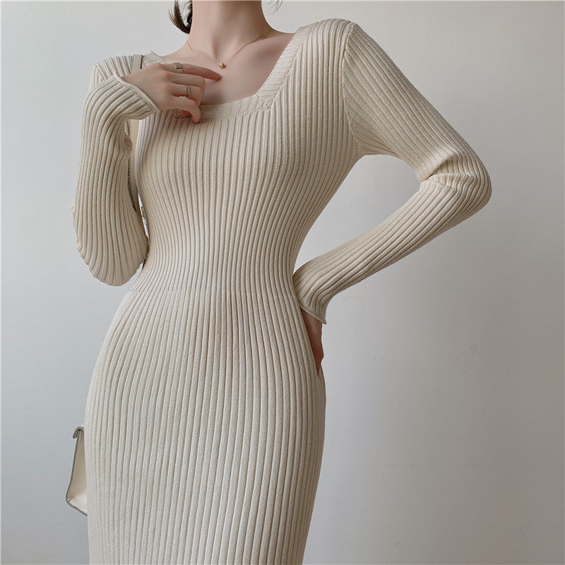 Close-up of a woman wearing a beige ribbed knit midi dress, showing the texture and square neckline.